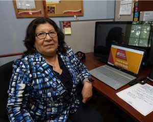latina-health-worker-office-desk-hero latina health worker office desk hero