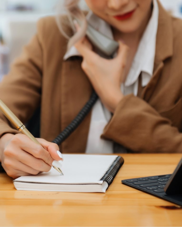 telehealth-coordinator-taking-notes-on-call-content telehealth coordinator taking notes on call content